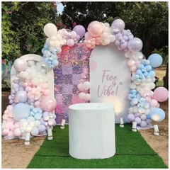 An outdoor birthday setup with a beautiful pastel balloon arrangement. The decor features a shimmer wall and is perfect for a "Five is a Vibe" themed party.