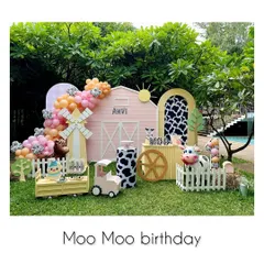A wide shot of our 'Moo Moo' birthday setup. A pink barn, a windmill, and a cute cow in a picket fence create a perfect farm scene.