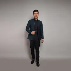 A sharp, tailored blazer in a deep teal. This piece is perfect for a reception or formal dinner, easily paired with black trousers for a sleek, contemporary look.