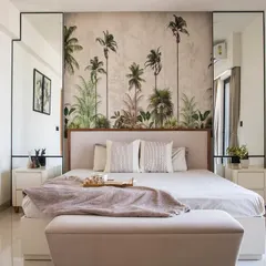 This bedroom is designed as a personal sanctuary. The tropical-themed wallpaper creates a focal point and a sense of escape, while the neutral color palette, clean lines, and soft textures make the room feel calm and restful.