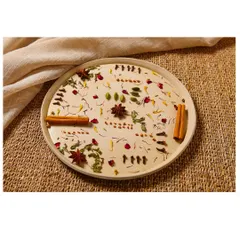 An artistic flat lay of tea ingredients like cinnamon, star anise, and rose petals. This type of shot is excellent for social media content and brand storytelling, highlighting the natural origins of the blend.