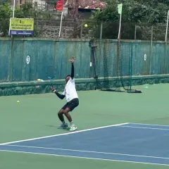 Coach Raju in action, demonstrating the powerful serve that made him an ITF World Masters Champion. Our players learn from the best.