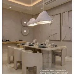 This dining room is a study in sculptural forms. The custom table, curved chairs, and unique pendant light create a harmonious composition, proving that great design quietly shapes how we feel and connect.