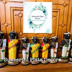 A collection of four sets of Marapachi dolls in different sizes, all dressed in traditional dhotis and sarees, ready to be sent to a client.