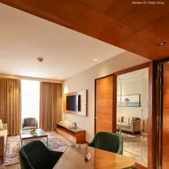 This view shows the layout of our deluxe suite, with a small dining table and a glimpse into the separate living area, offering plenty of room to spread out.
