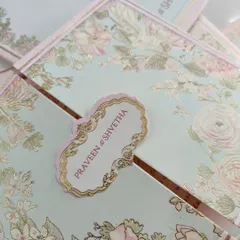 An elegant pastel lotus-themed wedding card. This design features a gatefold opening with a beautiful name tag, capturing the beauty of tradition with a modern touch.