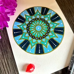 This mandala uses shades of blue and teal to create a calming, ocean-like feel. The simple patterns and soothing colors make it a perfect piece for finding a moment of peace.
