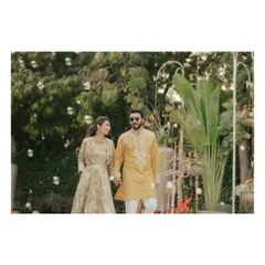 Nikita and Pushkar make their entrance at their Haldi ceremony, walking hand-in-hand through a path of bubbles. This shot captures the whimsical and happy atmosphere of their celebration.