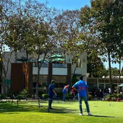 Friends enjoying a friendly putting competition. Our putting green is a great, low pressure activity for groups to engage in some lighthearted fun during a private party.