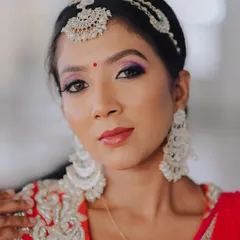 A classic beauty shot. The composition is tight and focused, capturing her flawless skin, elegant jewelry, and confident gaze.