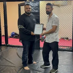 Receiving a certificate of appreciation. My goal is not just to train fighters, but to nurture talent from the grassroots level and provide a platform for them to grow and succeed.