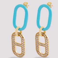 A vibrant product photo of modern link earrings, combining a turquoise blue enamel hoop with a pavé-set crystal link for a pop of color.