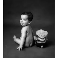 Sitting up, rolling over, and full of giggles. This simple, classic black and white portrait of a 6-month-old with his teddy bear captures the joy of this unforgettable phase.