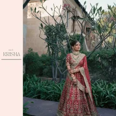 A full-length portrait of bride Krisha at The Westin Pushkar, showcasing her stunning Sabyasachi lehenga amidst lush greenery. Our focus is on capturing the elegance of the bride and her attire.