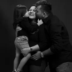 Welcoming a new baby is a family affair. This black and white portrait captures the pure, unscripted love and excitement between a mother, father, and soon-to-be big sister.