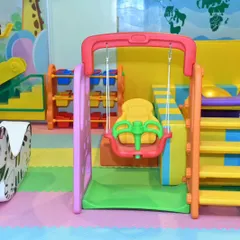 Another look at our toddler swing and slide combo. The soft, padded flooring and gentle equipment make it a worry-free zone for parents of young children.
