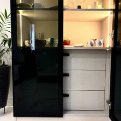 A detailed look inside my black-framed crockery unit, showing the combination of open shelving and deep drawers. The interior is finished in a light grey laminate, providing a beautiful contrast and clear visibility of your items.