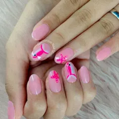 An underwater adventure. This sweet manicure features a soft pink base with adorable, hand-painted fish and starfish designs.