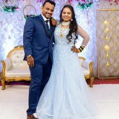 A lovely photo of the couple at their reception. The bride is wearing a modern gown but has kept a touch of tradition with her green bangles. Her makeup is fresh and elegant.