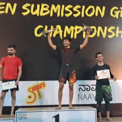 Our fighter stands tall on the podium, taking first place in his division at the PKD Open. This win is a direct result of countless hours spent mastering takedowns and submissions.
