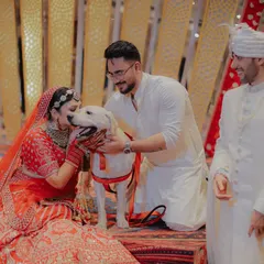 Even the furry family members get to be part of the celebration! The bride sharing a sweet moment with her dog on her wedding day is a heartwarming and unforgettable memory.