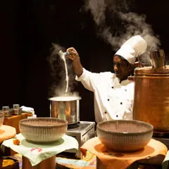 The steam rising from the pot tells a story of flavours being brewed to perfection. Our chef is preparing a traditional hot beverage, ensuring every cup is served with warmth and authentic taste at our live counter.