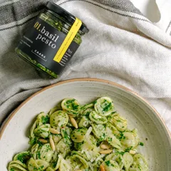 A comforting bowl of orecchiette pasta tossed with our fresh basil pesto and topped with pine nuts. This simple, delicious meal shows how our pantry essentials can create an incredible dish in minutes.
