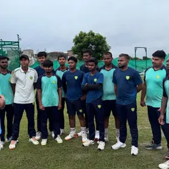 A team huddle before a practice session. Our coaches use these moments to instill strategic thinking and reinforce the importance of discipline and listening, key traits of a successful cricketer.