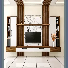 A symmetrical TV unit design featuring a central marble panel flanked by wood fluting and closed storage cabinets for a balanced and elegant look.