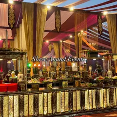 A grand and opulent catering display, with a long, ornately designed buffet counter laden with a wide variety of delicious offerings.