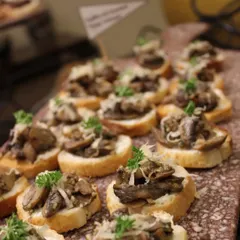 Our wild mushroom bruschetta is a crowd favorite. Sautéed mushrooms are served on toasted bread and finished with parmesan and fresh parsley, offering a simple yet sophisticated appetizer option.