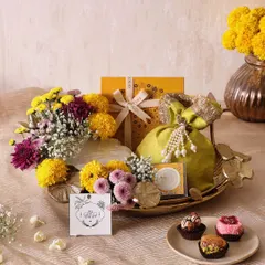 Our Lotus Marigold Tray is a perfect blend of elegance and indulgence for Diwali. It features an Urli candle, truffles, sugar-free mithai, and honey choco almonds, all beautifully arranged on a metal tray.