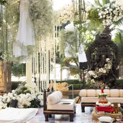 Set against a serene poolside, this mandap is a study in timeless elegance. I combined a profusion of classic white florals and fresh greenery with the divine presence of a Ganesha sculpture, creating a space that feels both sacred and seamlessly integrated with nature. This design showcases my ability to craft sophisticated outdoor ceremonies.