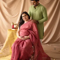 A classic portrait of a couple in ethnic wear. His hand on her shoulder, they present a picture of strength and togetherness.