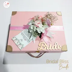 Our "Bridal Bliss Bundle" comes in a beautiful pink suitcase-style box, personalized with her name and a floral arrangement. It's a keepsake she'll treasure long after the wedding.
