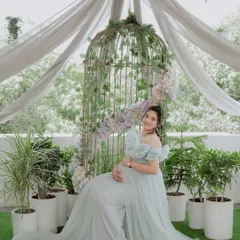 Our popular birdcage setup. Draped with soft fabric and adorned with flowers, it creates a romantic and whimsical backdrop for any gown.