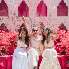 Pure fun at a Mehendi ceremony. The vibrant pink backdrop and fuchsia couch, surrounded by bougainvillea, created a lively and energetic space for the bride and her friends to celebrate.