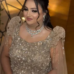 A beautiful portrait of the client, looking radiant and confident. The updo hairstyle and statement jewelry complete her elegant evening look.