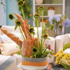 A closer look at the unique floral arrangement, where sunflowers and wildflowers are mixed with fresh bread for a rustic, harvest feel perfect for the Hundred Acre Wood.