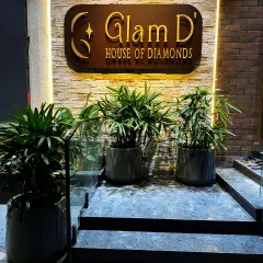 First impressions matter. For the 'Glam D' House of Diamonds, we designed an elegant entrance using a trio of potted palms and sophisticated lighting to create a welcoming and luxurious atmosphere for their clients.