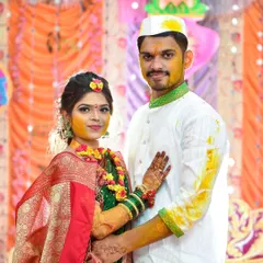 A portrait of the couple after their Haldi ceremony, showcasing the afterglow and traditional green and red attire.