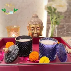 My crystal jar candles look beautiful when styled in your home. Here, the black and purple jars are set on a tray with marigold flowers, creating a serene and festive atmosphere perfect for Diwali.