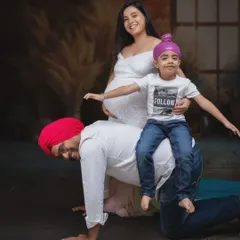 Moments like these capture the heart of family. A playful dad, a spirited child, and a mom-to-be glowing with joy and anticipation.