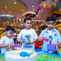Three boys enjoying the sensory sand table during our Holi celebration. It's a great activity for creative and imaginative play, no matter the occasion.