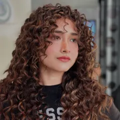 I believe in working with your curls, not against them. This look is all about defining the natural pattern to create bounce, shape, and incredible volume without the frizz.