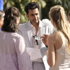 Explaining the setup for a card trick to a group of guests. The key is to draw people in and make the magic happen right in their own hands, creating a truly interactive experience.