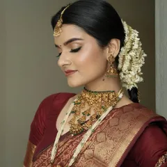 With eyes gently closed, you can see the soft, shimmering eyeshadow work. I use tones that enhance the richness of the bridal attire, creating a look of serene elegance.