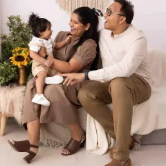 Pure, unscripted laughter is my favorite thing to capture. This candid moment shows the joyful connection between parents and their little one during a relaxed studio session.
