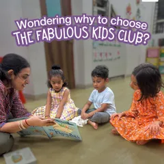 This is a quiet moment during a storytelling session. An instructor sits with a small group of children, reading a book and creating a calm, focused environment. This is how we build a foundation for a love of reading.