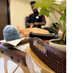 Creating a peaceful atmosphere is part of the service. Here you can see our therapist setting up for a session, ensuring your space becomes a haven for healing.